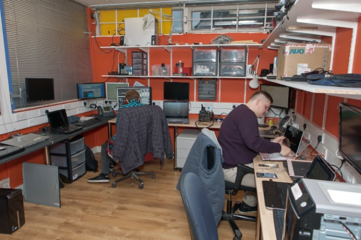 Our technician repairing a laptop and desktop computer in the office